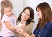 Injured girl with mom and doctor