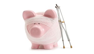 Piggy bank with bandage and crutches